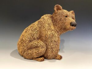 Clay sculpture of brown bear.
